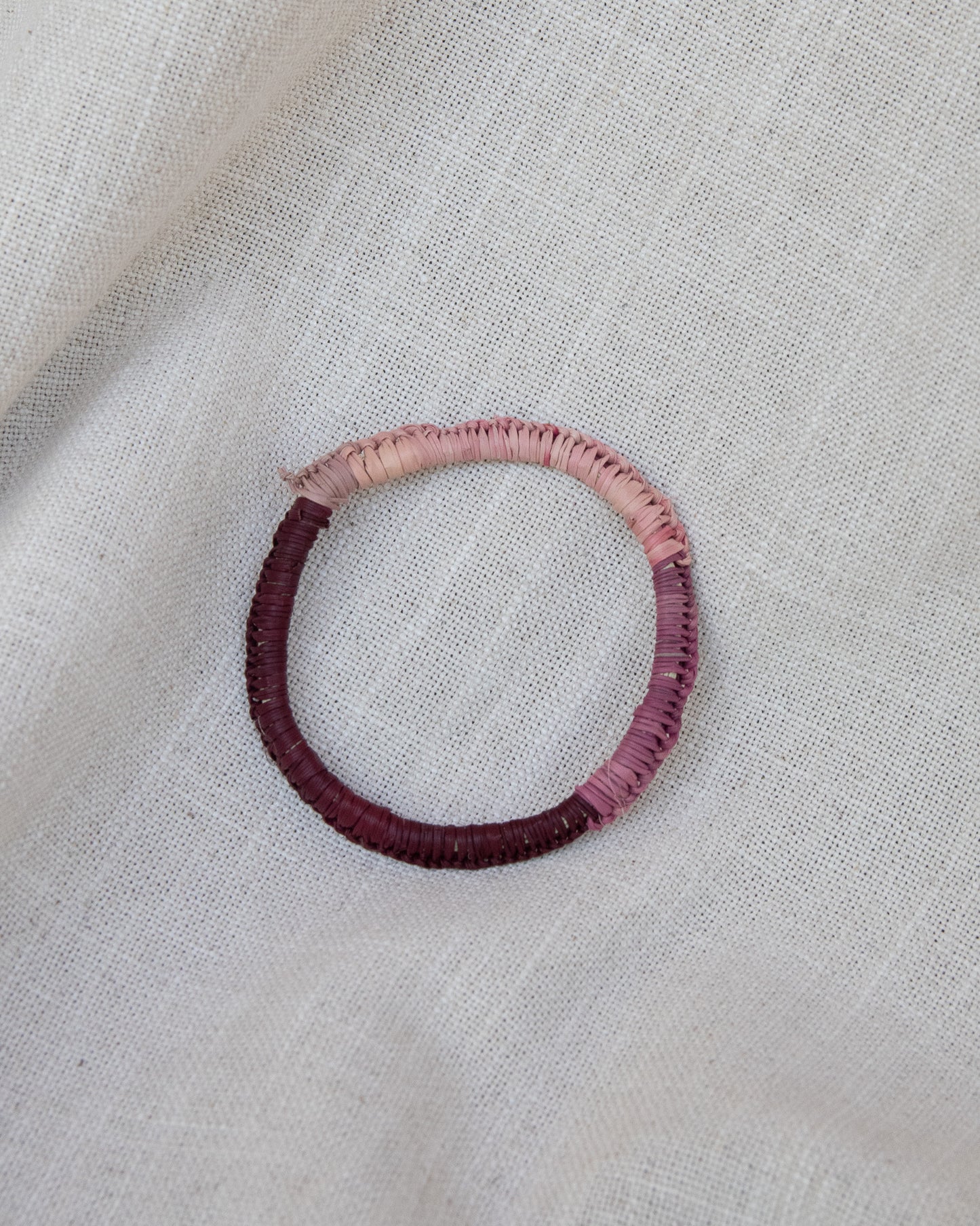 Shades or pink woven bangle by aboriginal artist
